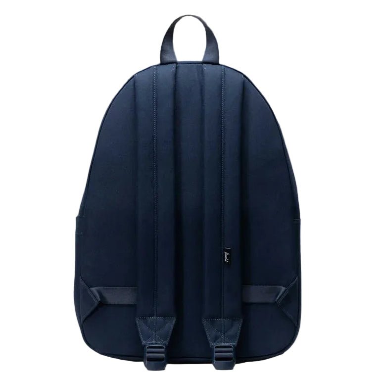Navy blue backpack on a gray background