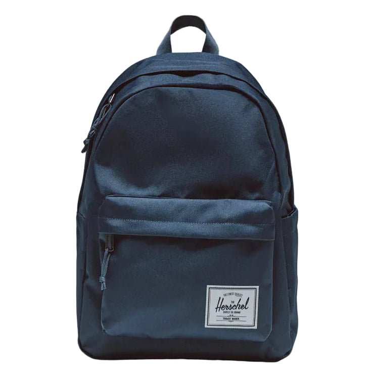Navy blue backpack with a visible brand logo on a gray background