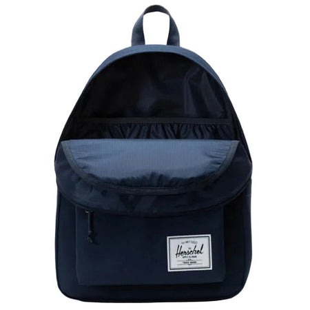 Navy blue backpack with Herschel logo on a gray background